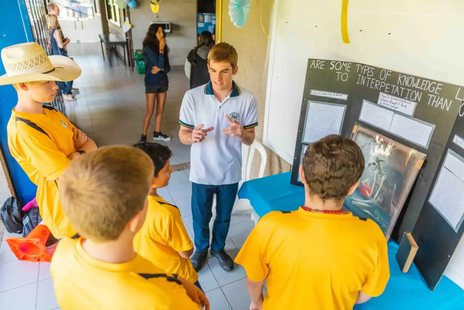 Students presenting a science project in a vibrant school corridor, emphasizing academic excellence and engaging learning environments.