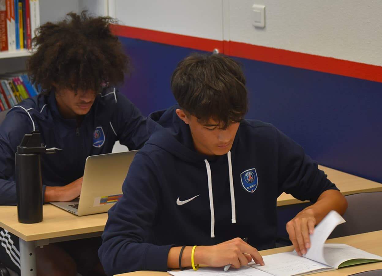 Bright students studying in a modern classroom at an international school, focusing on academics and personal growth.