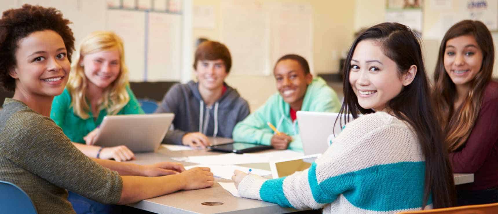 Happy diverse students studying together at World Schools, promoting global education and cultural diversity.