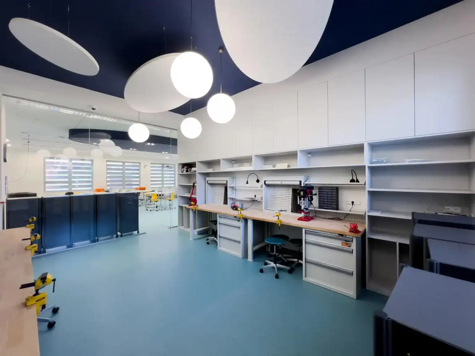 Modern STEM classroom with interactive workstations and bright decor for innovative learning.