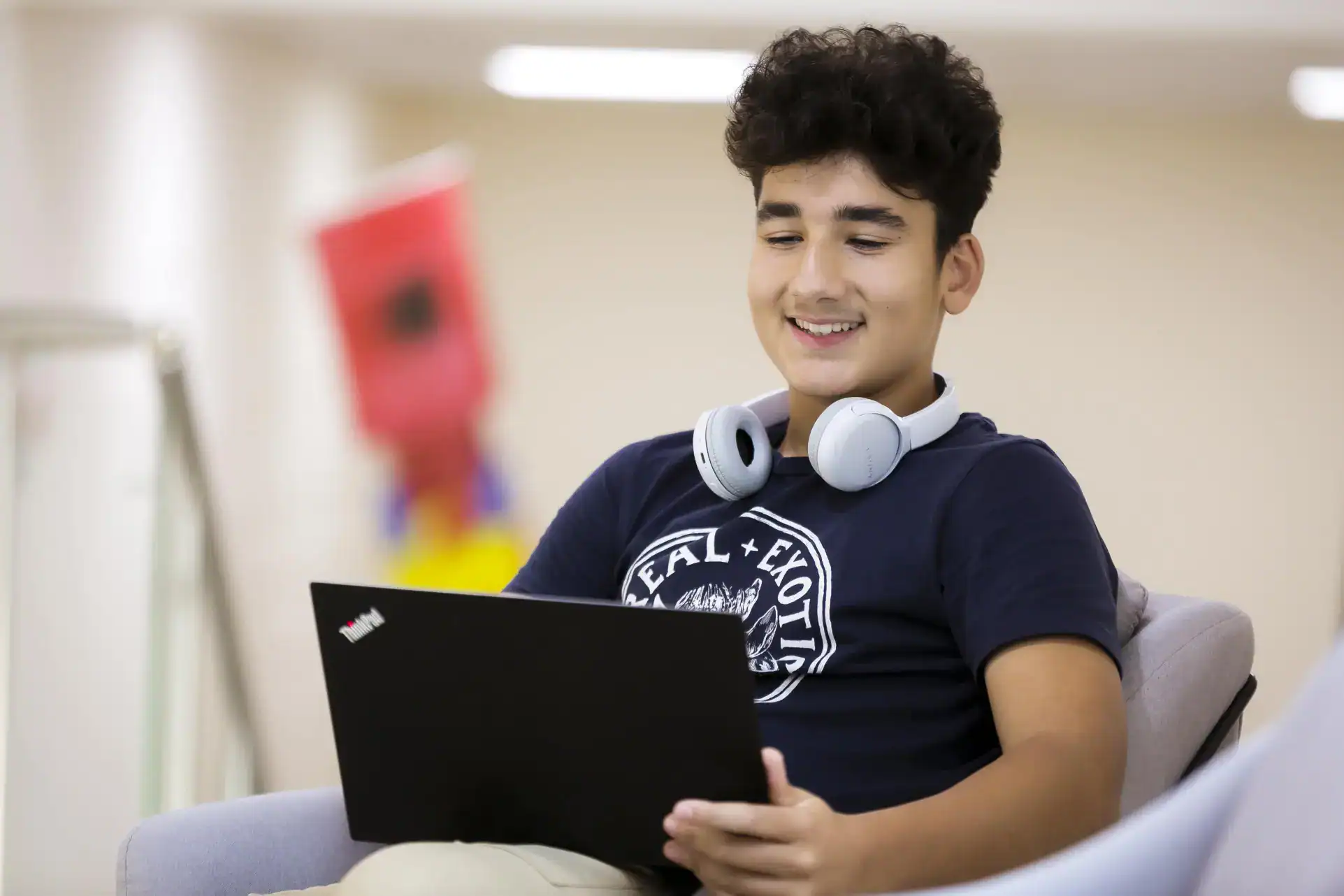 Young boy studying with a laptop at school, promoting world schools education.