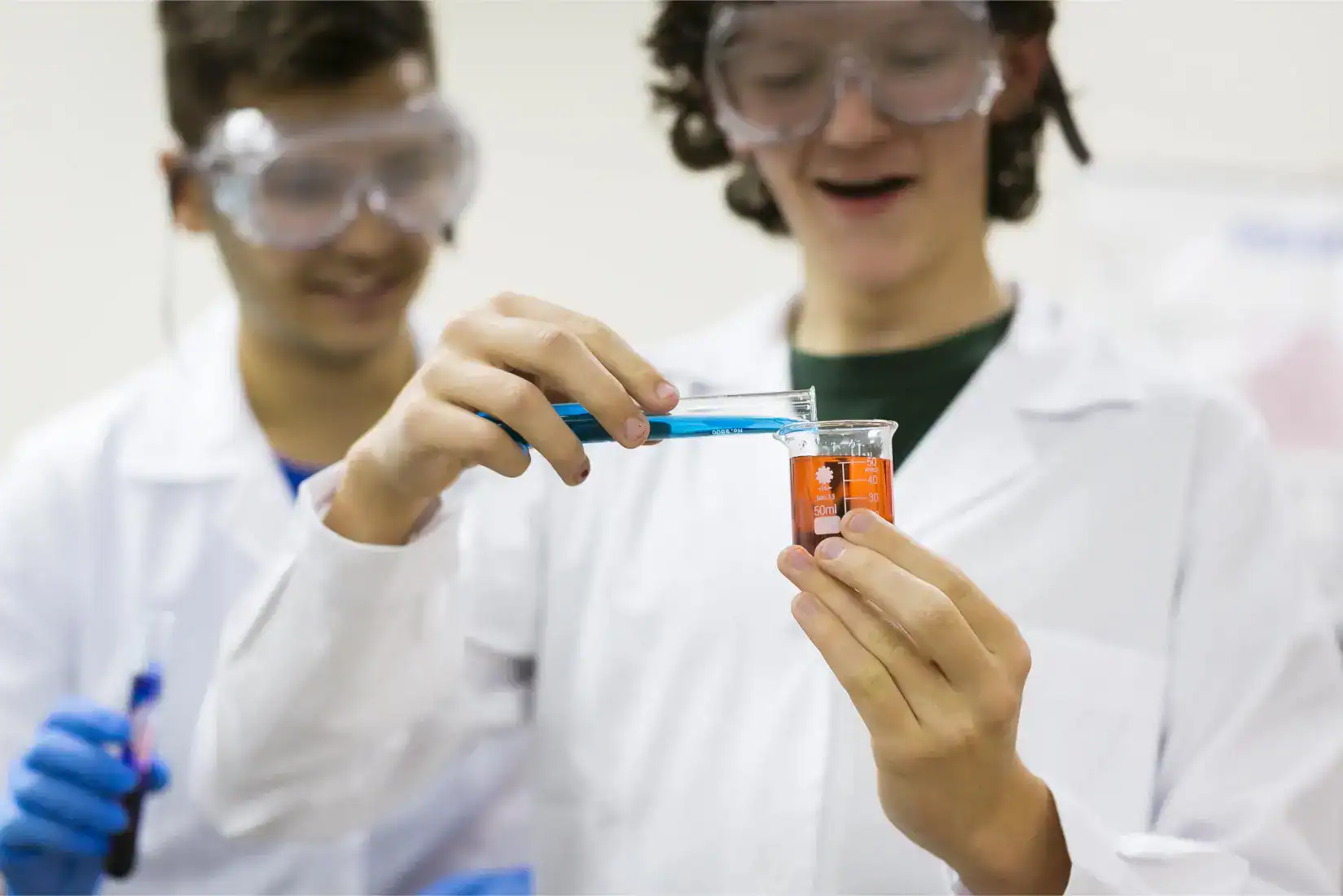 Children conducting science experiment in classroom, focusing on chemistry, discovery learning, and educational excellence.