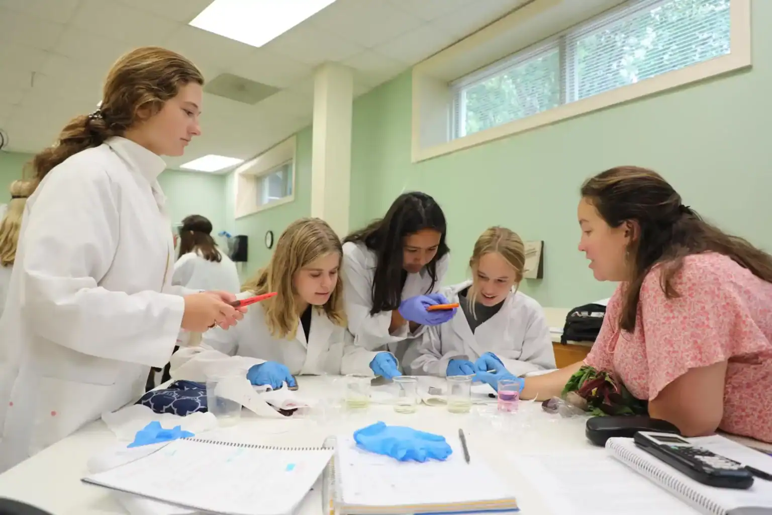 Innovative world school students collaborating in a science laboratory for STEM education.