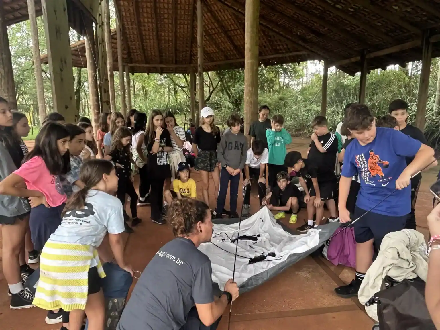 Students participating in outdoor educational activities at a nature school environment.