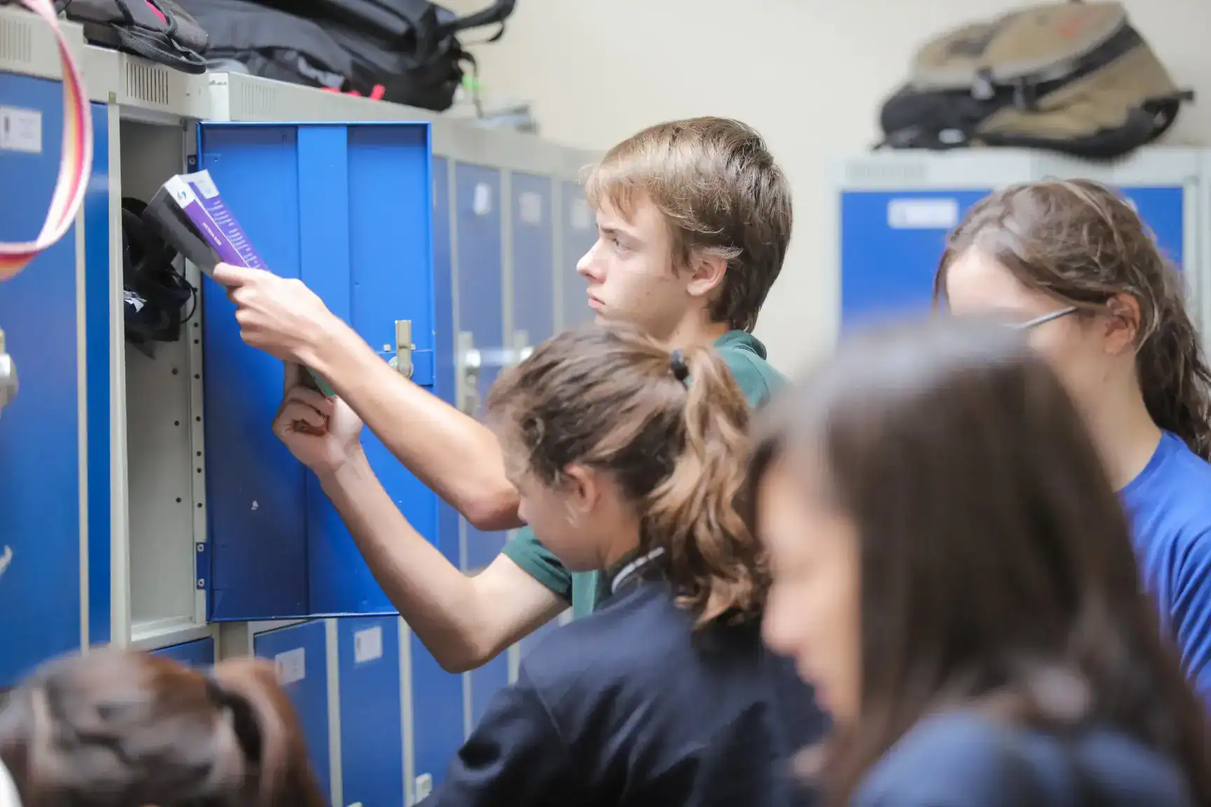 Innovative students engaging with lockers in a modern school environment.