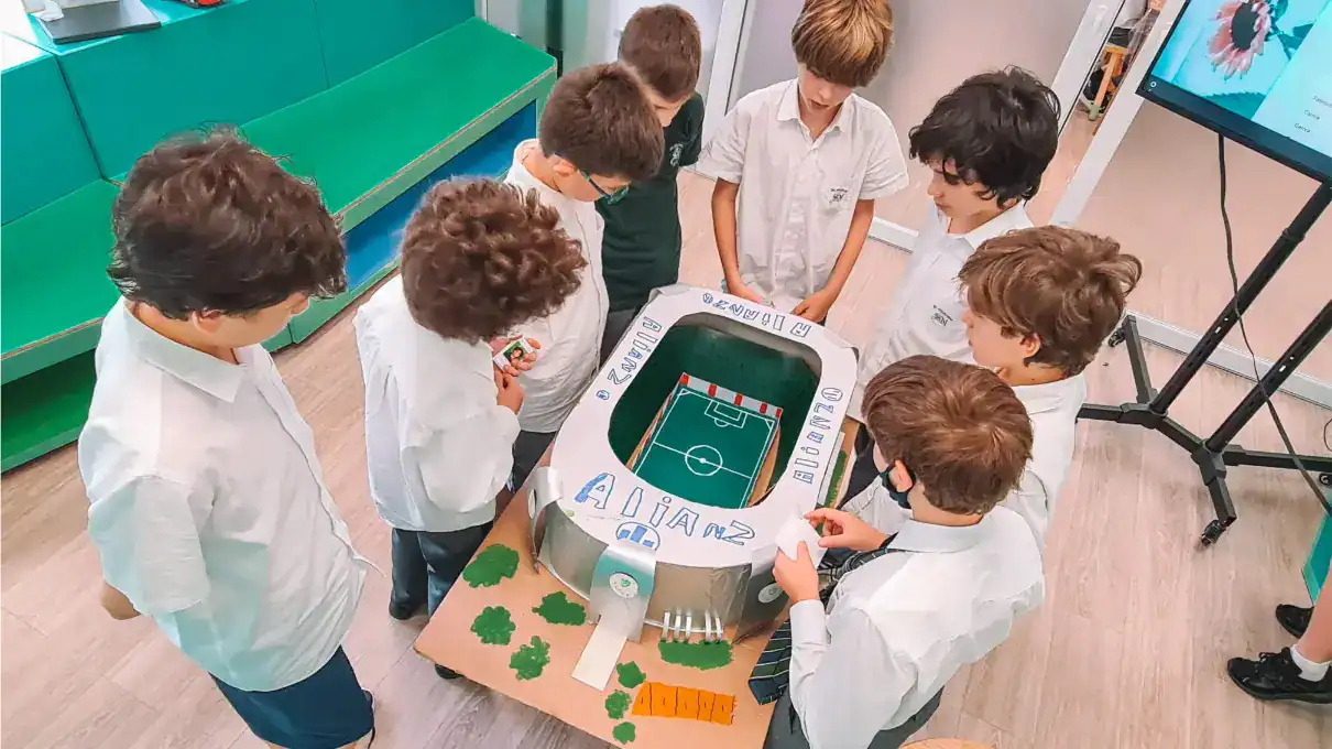 Kids engaging with a soccer-themed school project, fostering teamwork and creative learning.