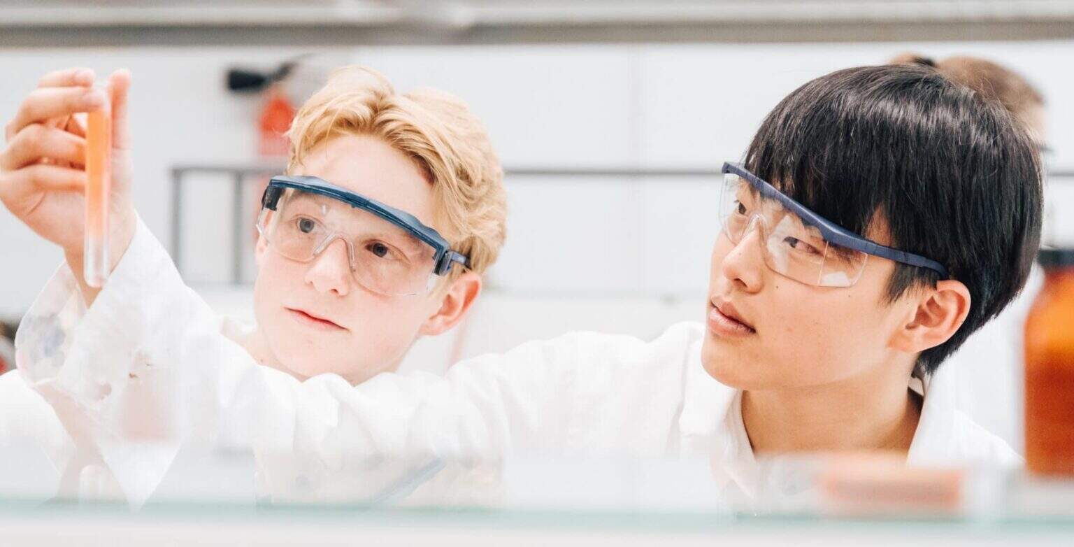 Innovative World Schools science lab with diverse students conducting experiments for optimal learning.