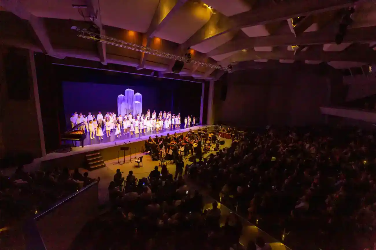 This Year at TASIS: 2023 17 Students performing on stage at a school concert or theater event.