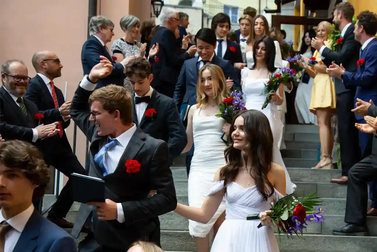 This Year at TASIS: 2023 19 Graduation ceremony at an international school, diverse students, waiting to graduate, celebrating achievement.