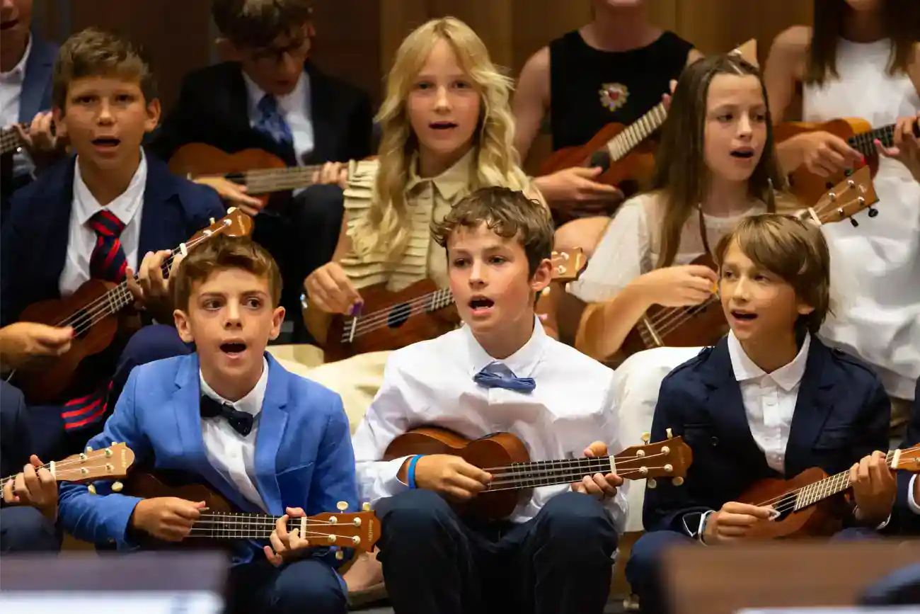 This Year at TASIS: 2023 23 Children playing ukuleles during school music performance at an international school event.