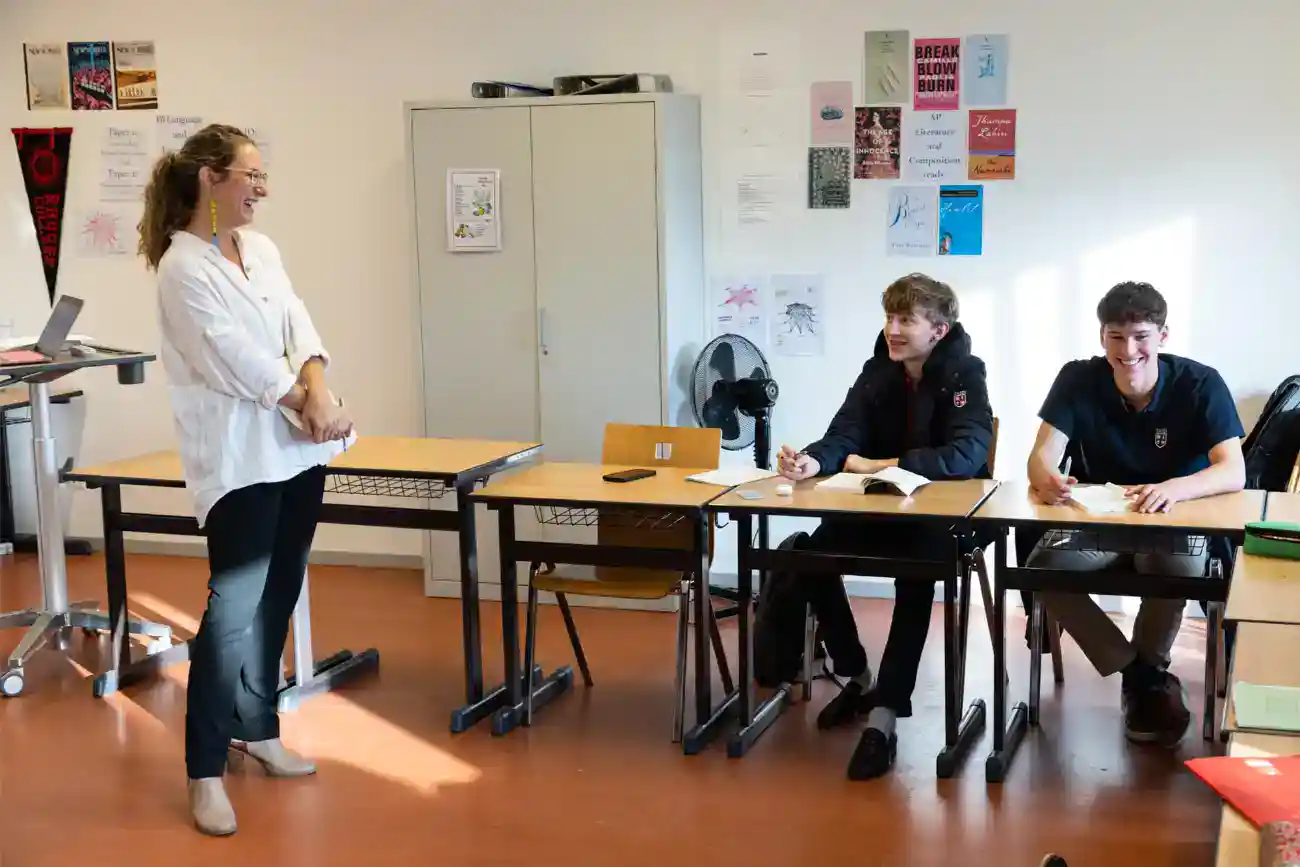 This Year at TASIS: 2023 27 Focused classroom scene at a private international school with engaged students and a teacher.