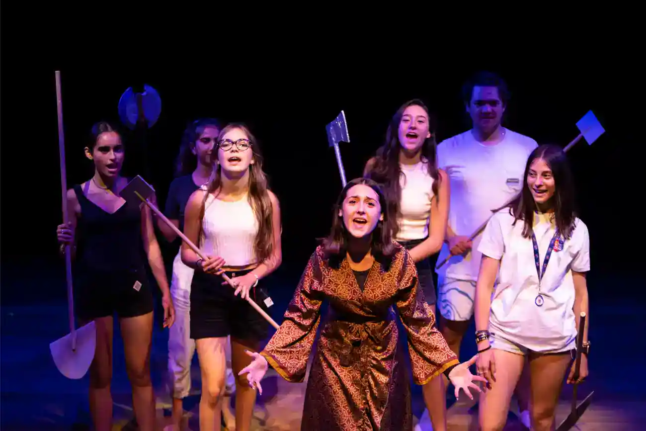 This Year at TASIS: 2023 30 Students performing a play or dance at a World Schools event, showcasing diverse talents and cultural education.