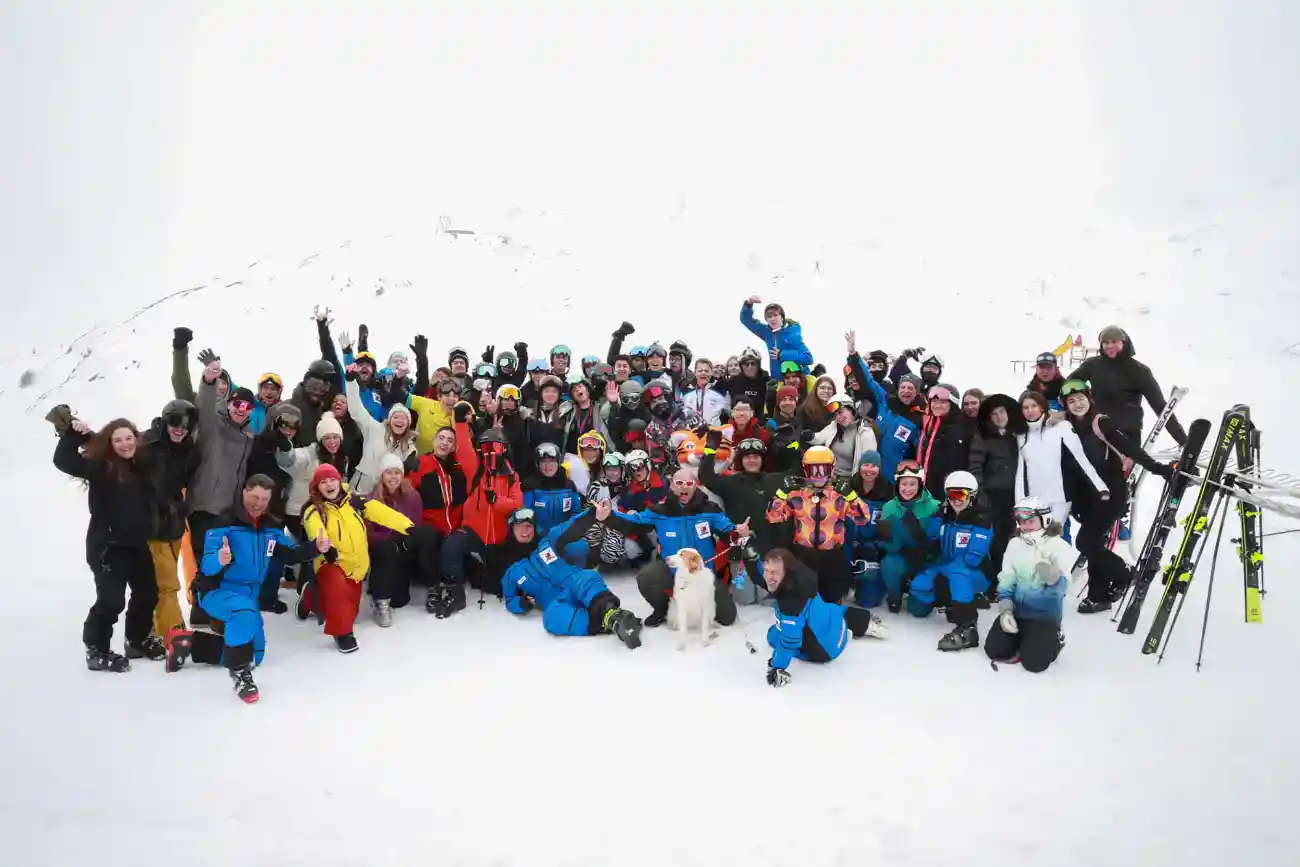 This Year at TASIS: 2023 9 Snow sports school group photo at a winter resort, students and instructors enjoying skiing and snowboarding activities.