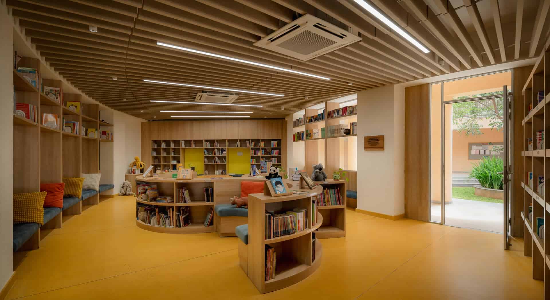 Bright modern library interior with bookshelves, seating areas, and natural light for a welcoming ed.
