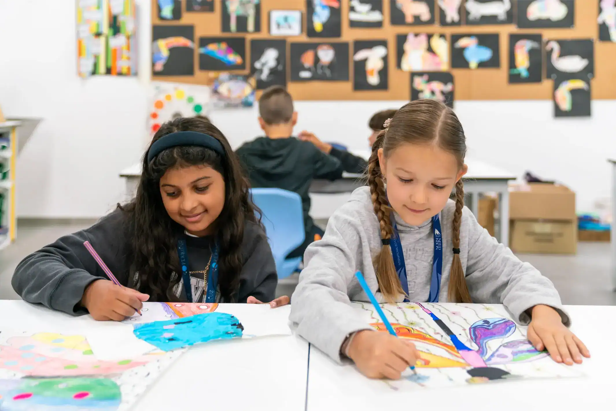 Brightly engaged students creating colorful artwork in a vibrant classroom at World Schools.