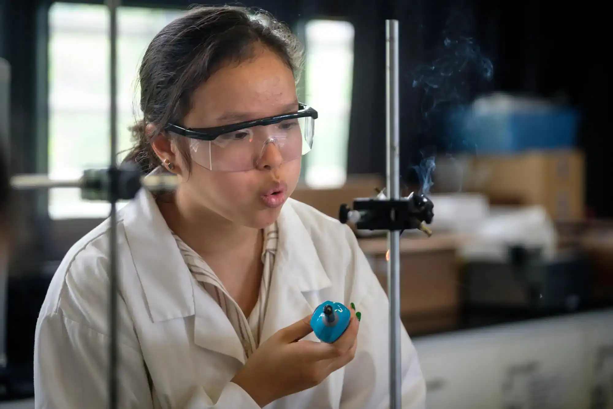 Innovative student conducting a science experiment in a well-equipped classroom, promoting STEM education at World Schools.