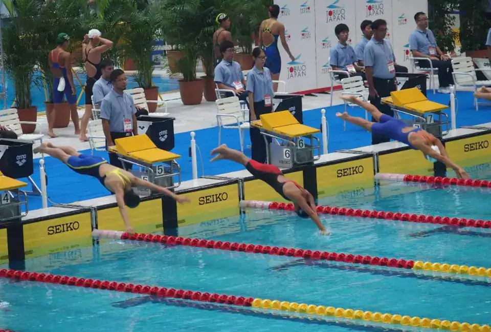 Competitive swimming race at World Schools Championship in Japan, showcasing elite athletes and global sports excellence.