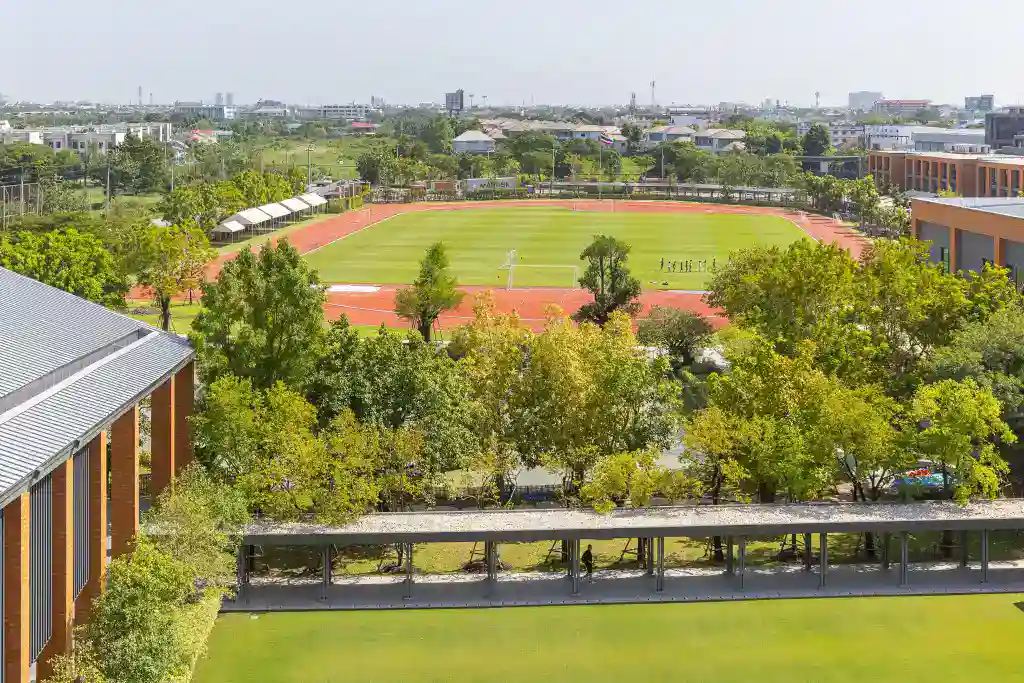 Modern school campus with sports fields and green spaces at World Schools.