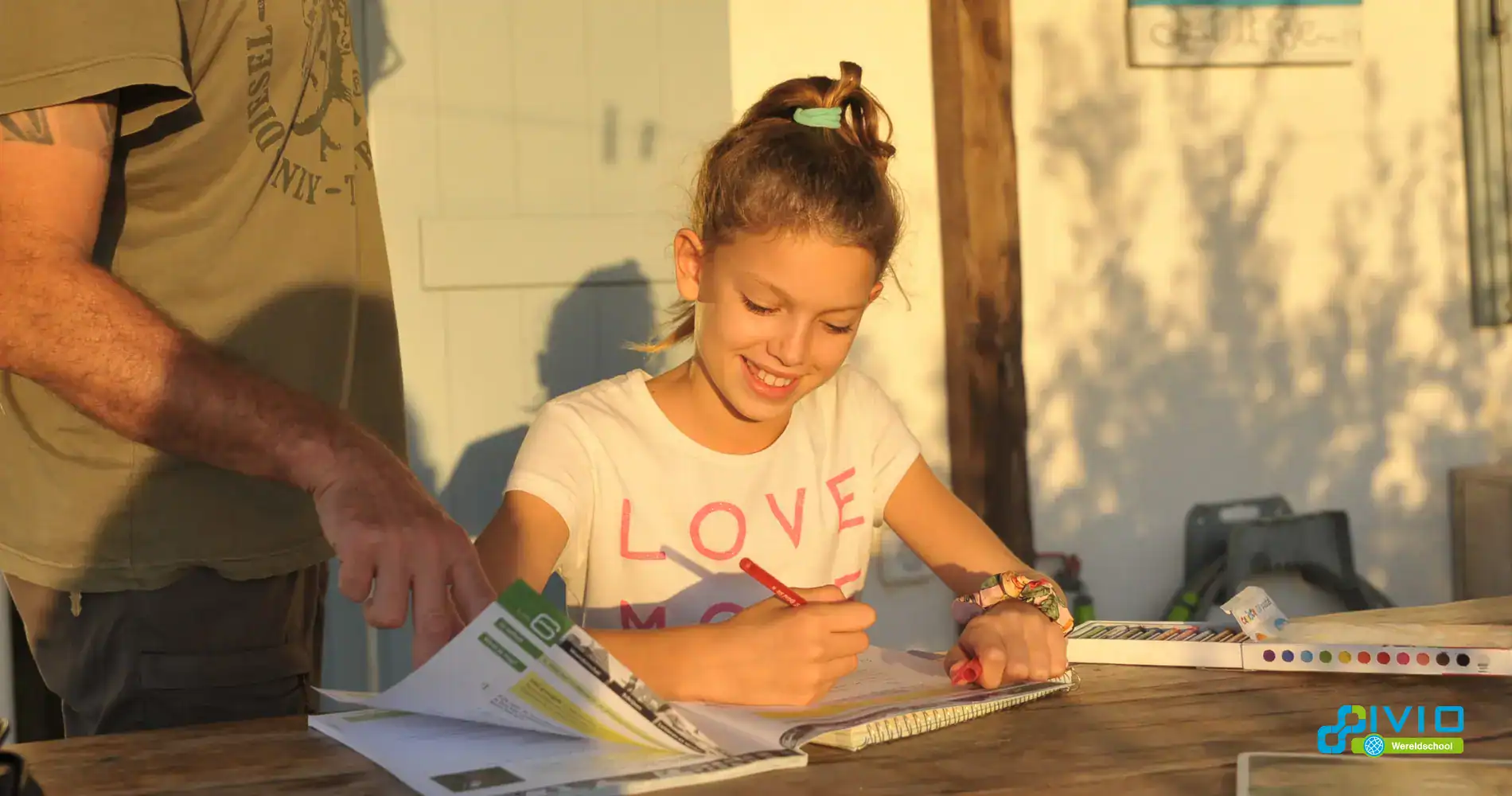 Bright young girl studying outdoors at sunset, engaging in global education at a World School.