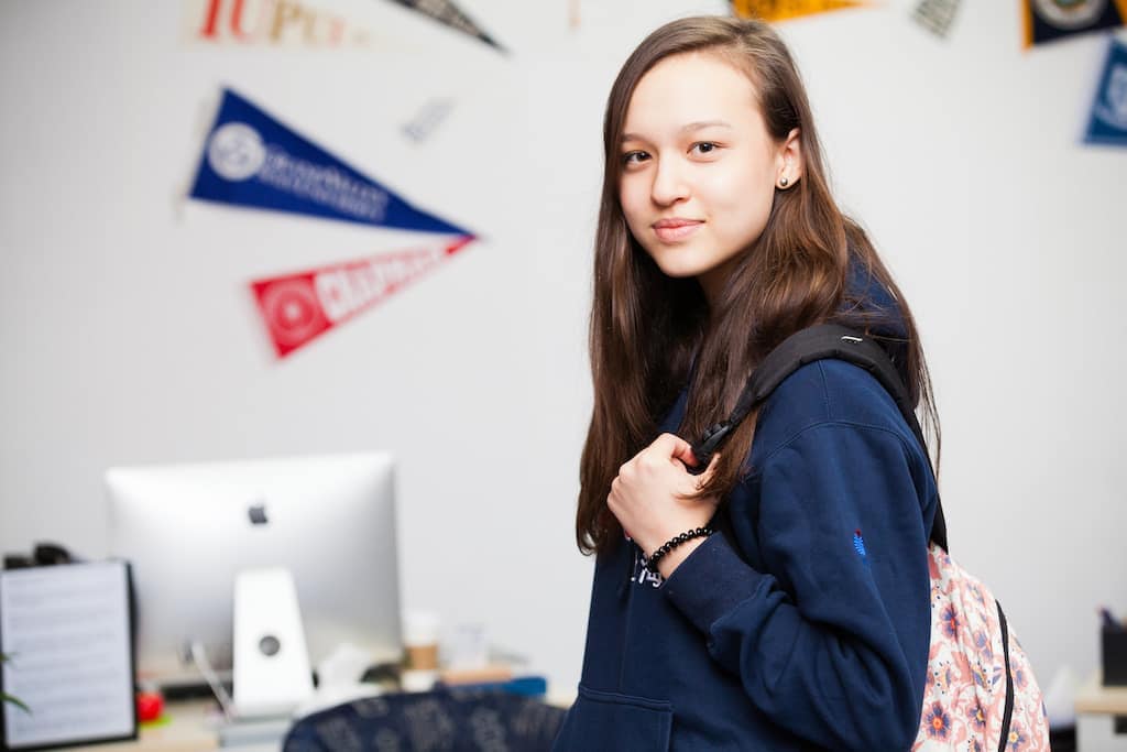Bright student with backpack, exploring world schools and global education opportunities.