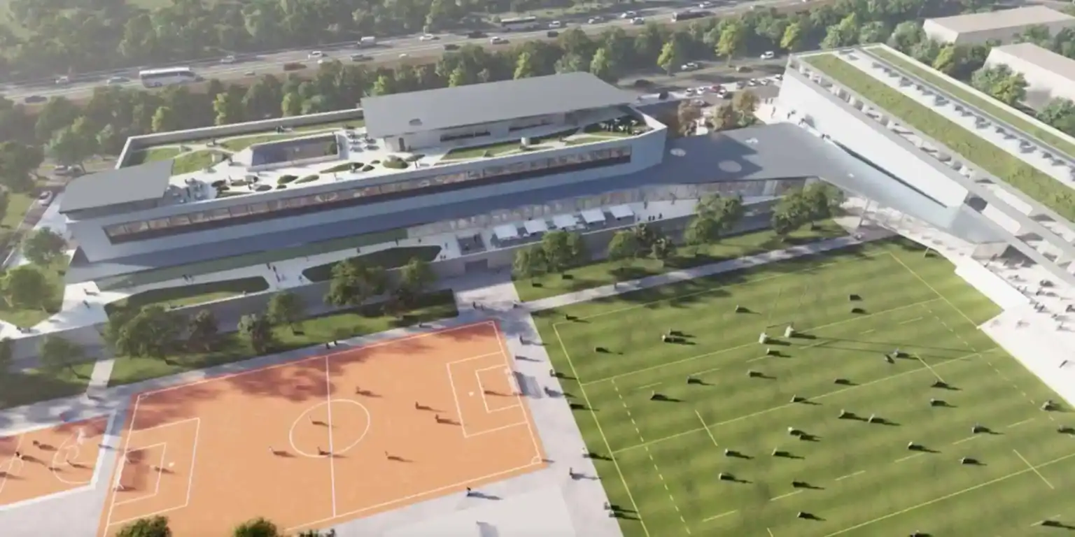 Modern school campus with sports facilities and green spaces for students' development.