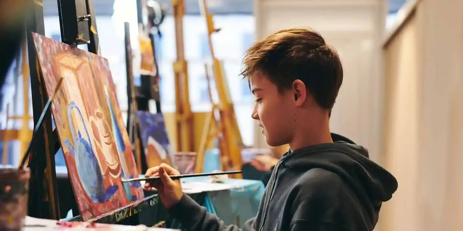 Colorful youth painting at an art class, showcasing creativity and artistic development in a vibrant school environment.