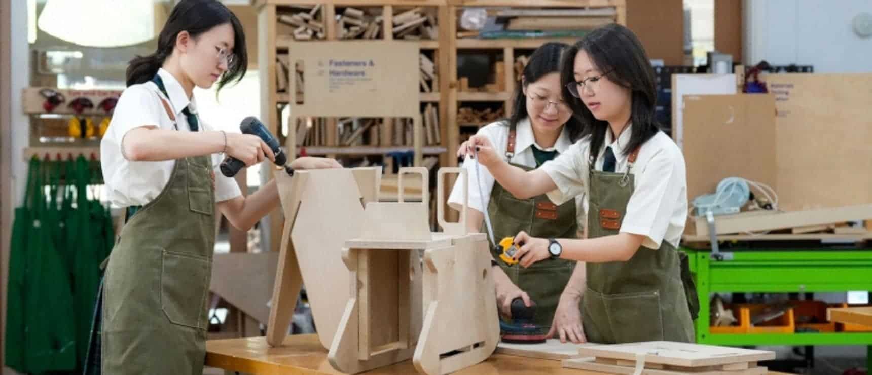 Students engaged in woodworking project at World Schools, fostering skills in STEM education and craftsmanship.
