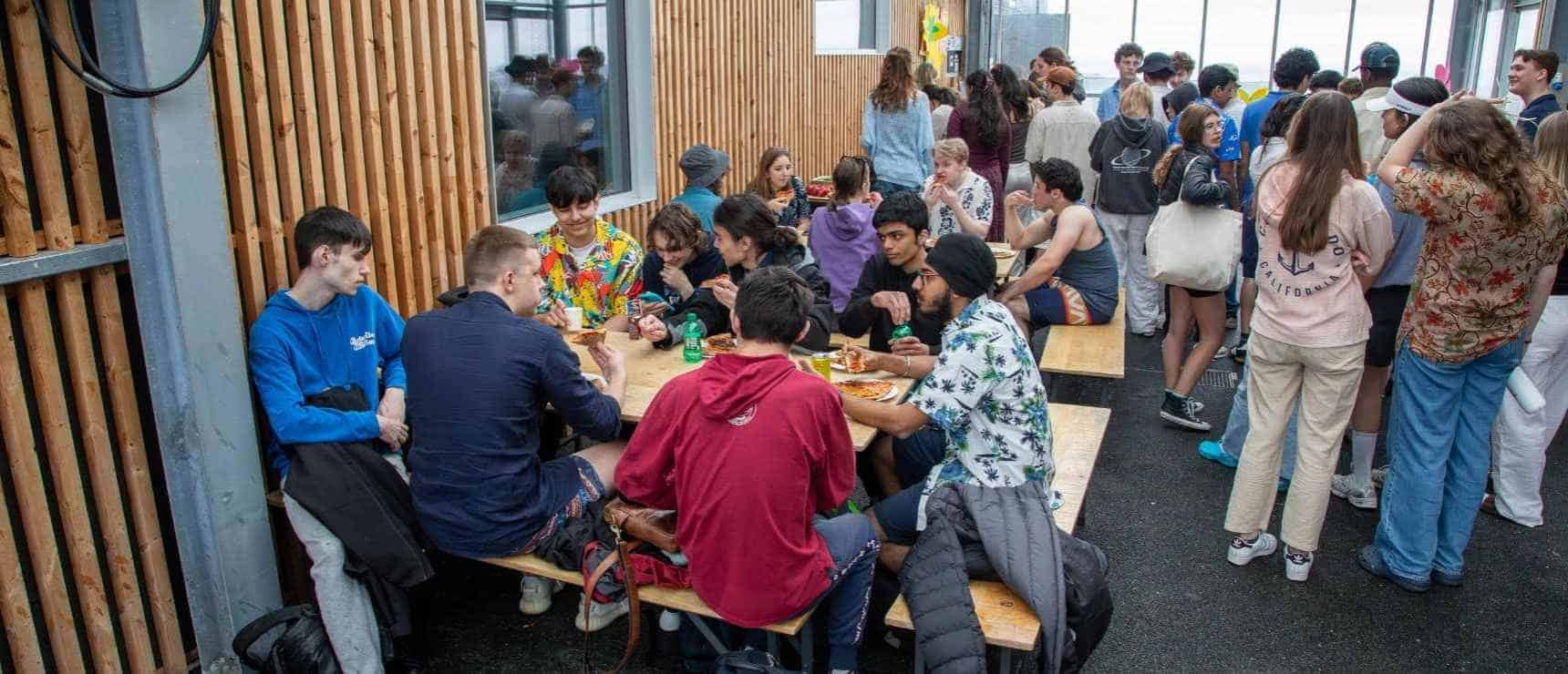 Students enjoying lunch at World Schools campus with diverse activities and vibrant community.