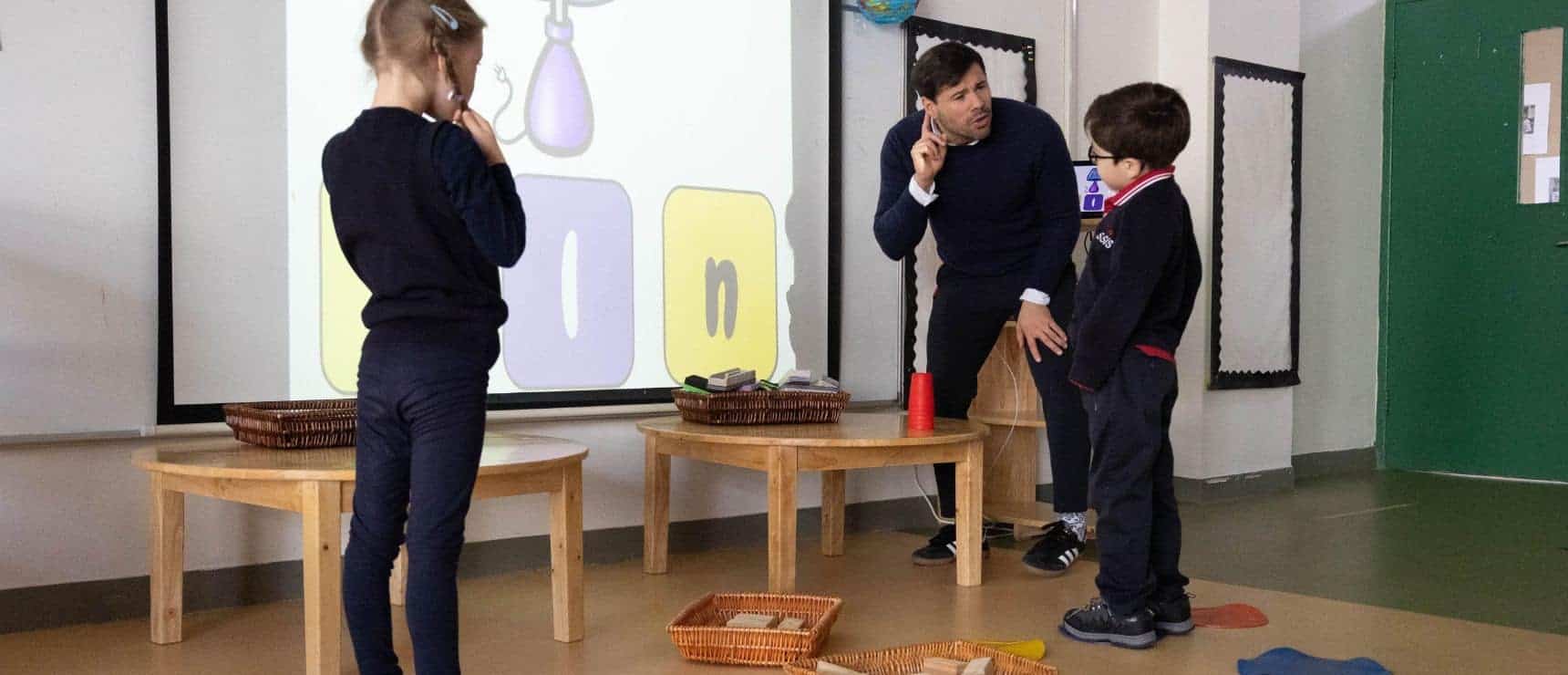 Interactive classroom with children and teacher engaging in a learning activity at a World Schools institution.