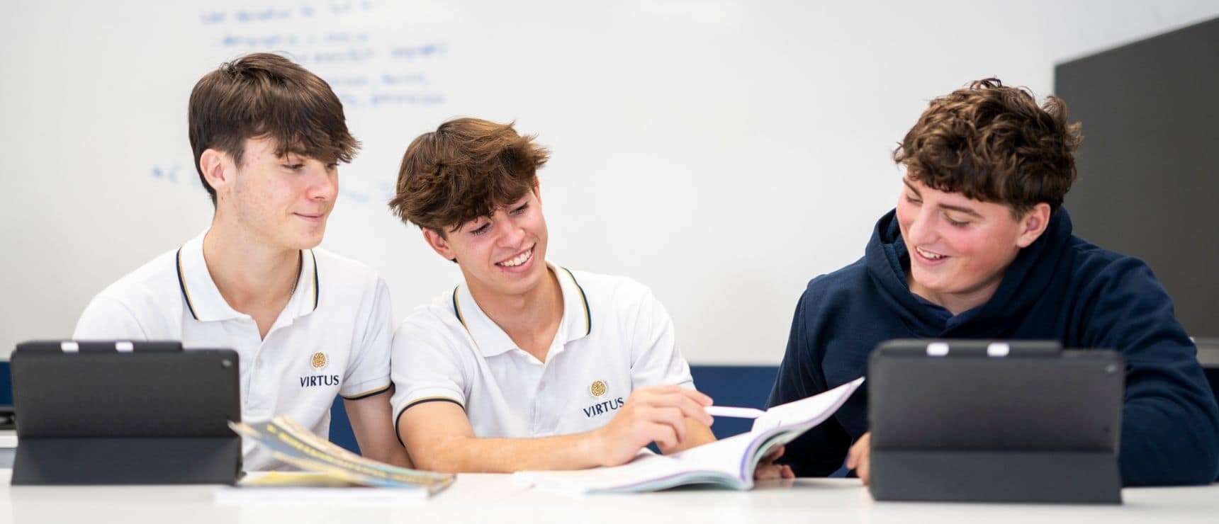 Focused students collaborating in a modern classroom at World Schools, enhancing academic success and global learning partnerships.
