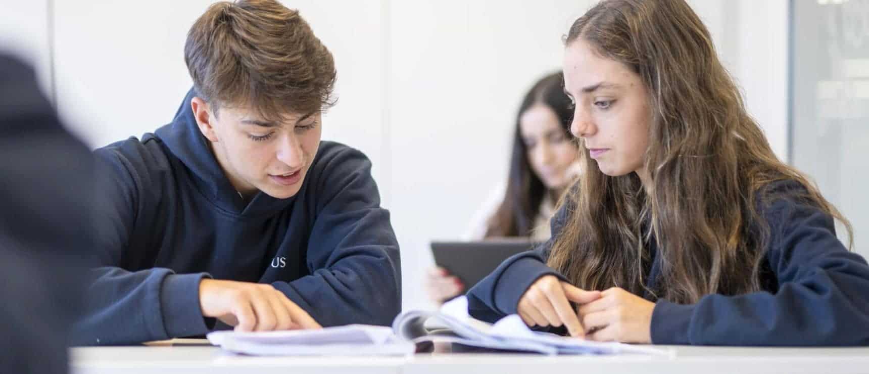 Engaged students studying together at a modern World Schools classroom to promote global education excellence.