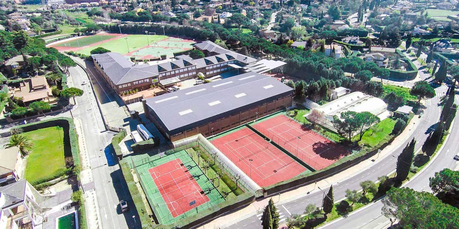 Spacious international school campus with multiple sports courts and lush greenery for student activities.