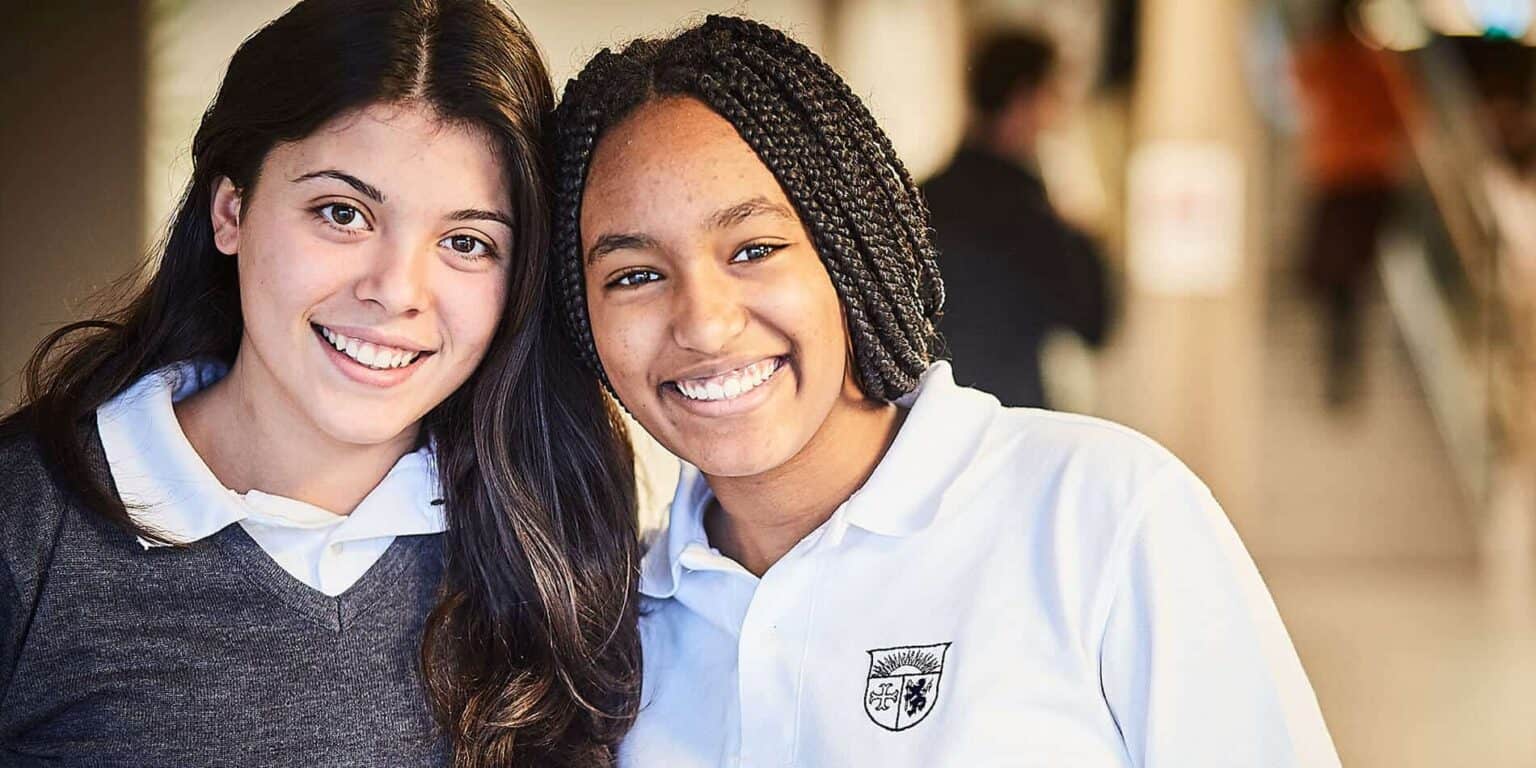 Diverse smiling students at World Schools promoting inclusive education and academic excellence.