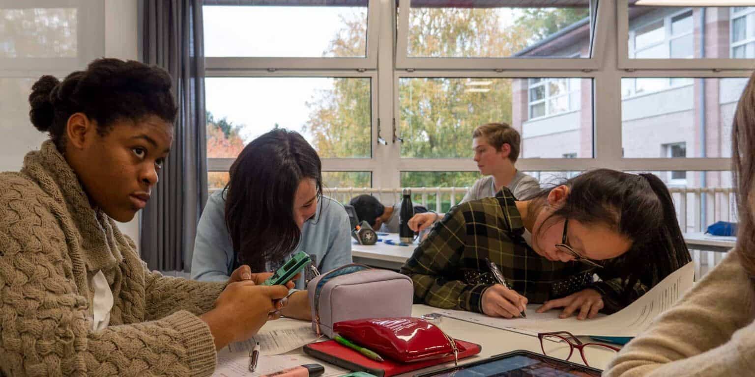 Focused students working collaboratively in a modern classroom at World Schools.