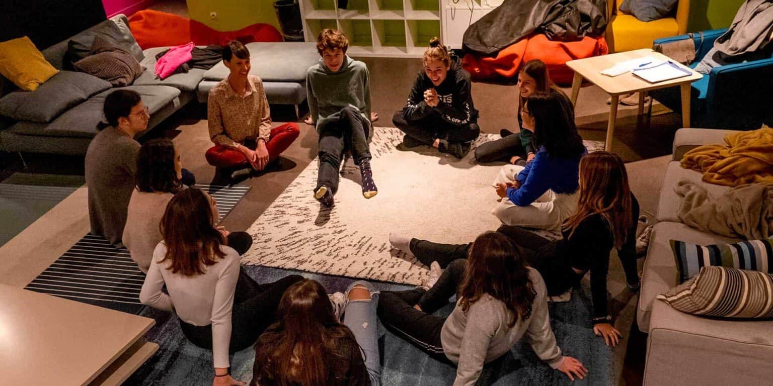 Children engaging in group activity at a World Schools program event.