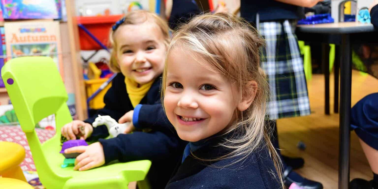 Children playing in classroom, happy students, early childhood education, school learning environment, young learners, school classroom setting.