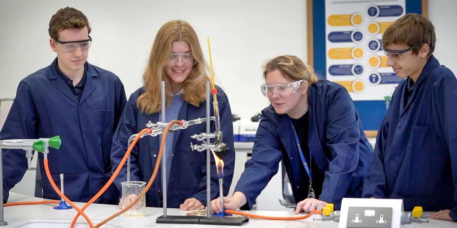Students performing science experiments in a laboratory at a world schools program.