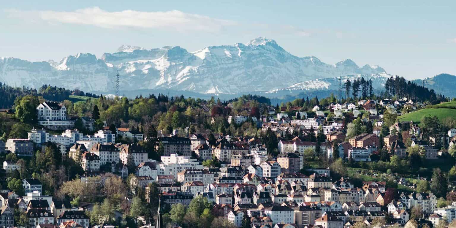 Colorful European town with snow-capped mountains in the background, showcasing scenic landscapes perfect for international student communities.