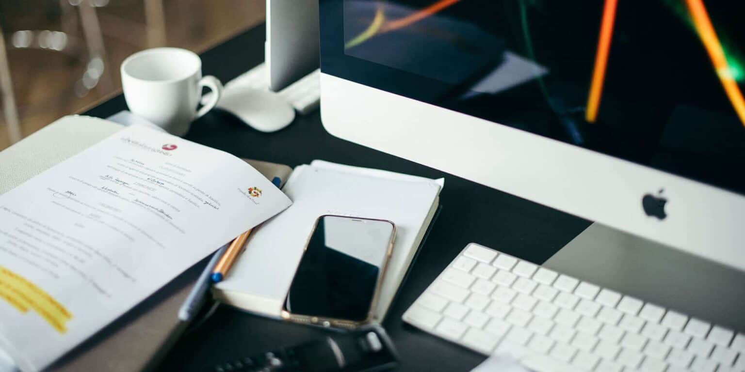 Innovative workspace with computer, documents, and mobile phone promoting modern education at World Schools.