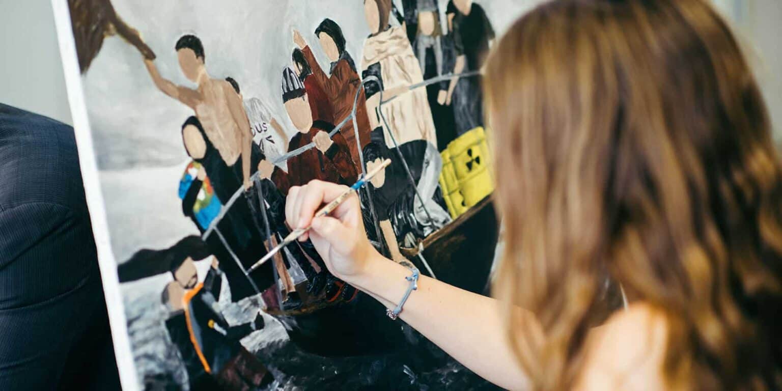 Children participating in a collaborative art project at a world school event, showcasing creativity and teamwork.