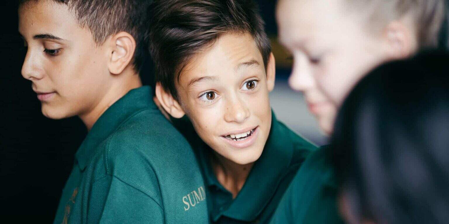 Bright young students engaged in a lively classroom discussion at a world school.