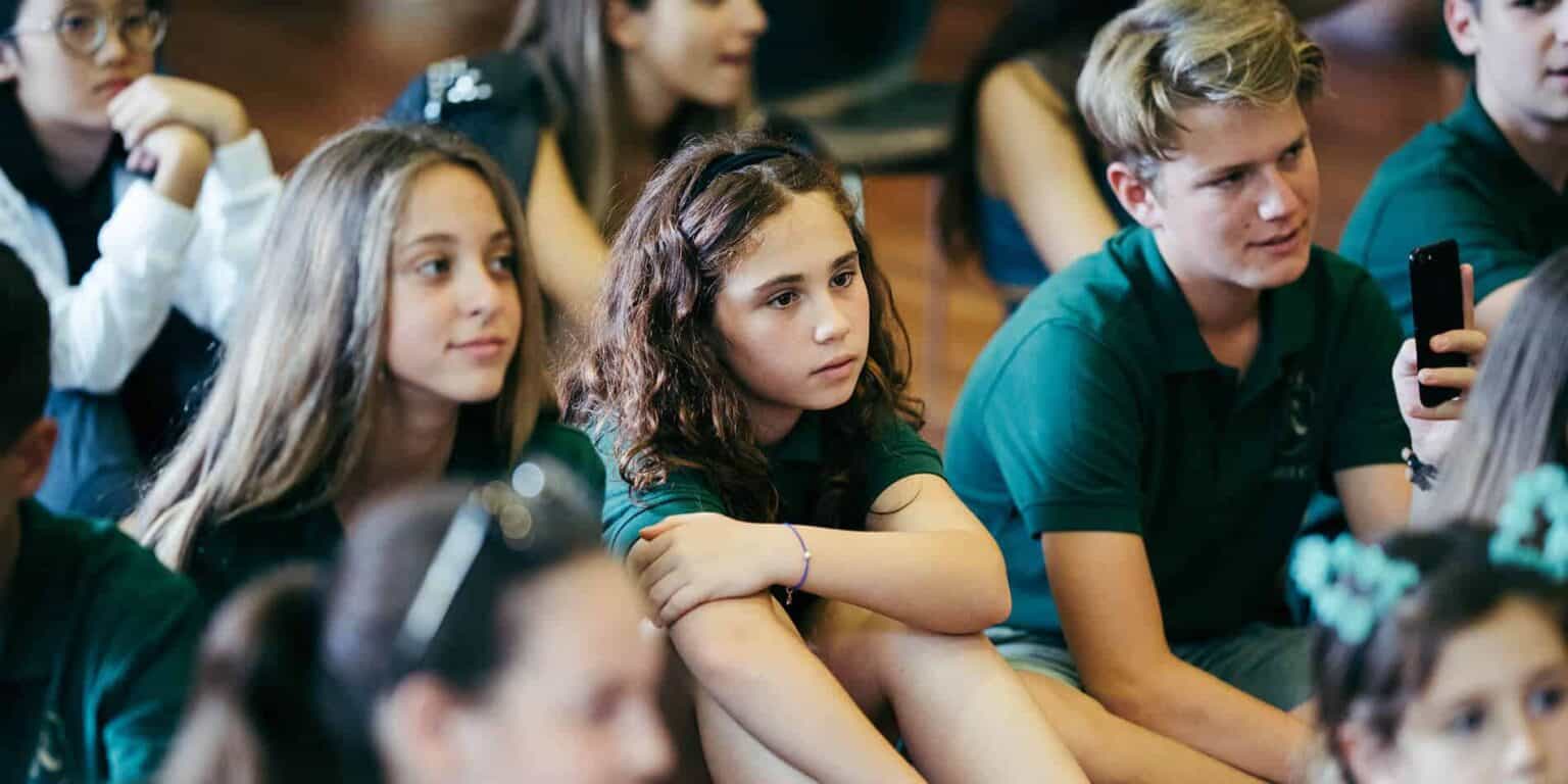 Focused attentive students at World Schools international education event, diverse learning environment, promoting global student success.