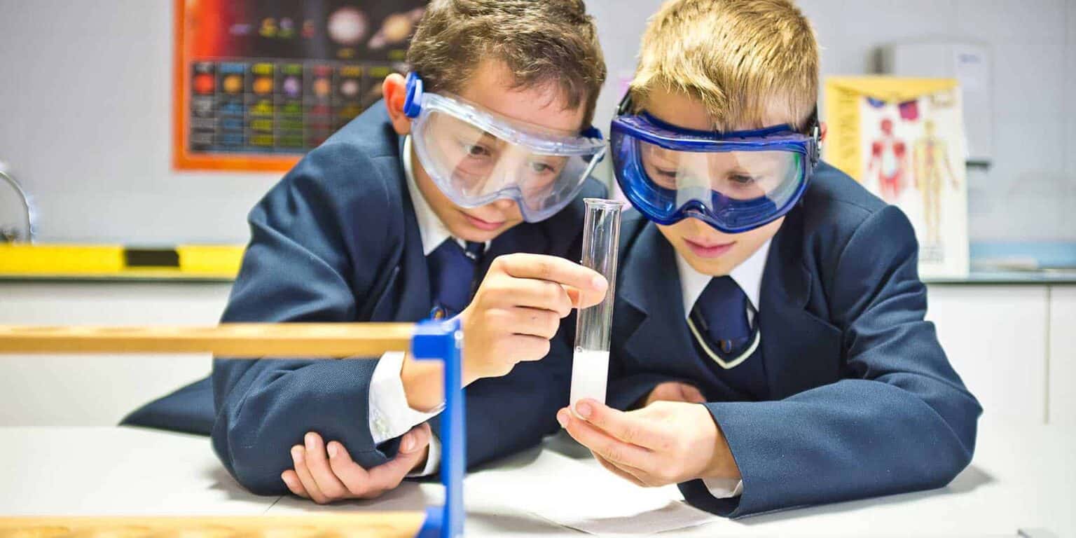 Students conducting science experiments in a modern school laboratory environment.