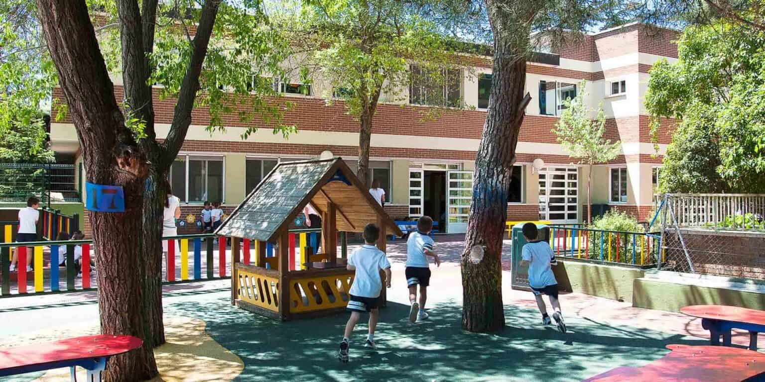 Bright outdoor playground with children running at World Schools, promoting active learning and development.