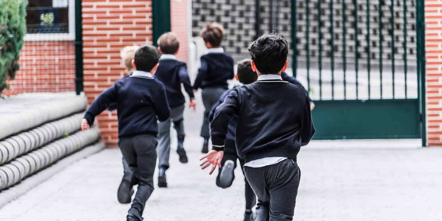 Children running outdoors at a private school playground – engaging in active play and socializing.