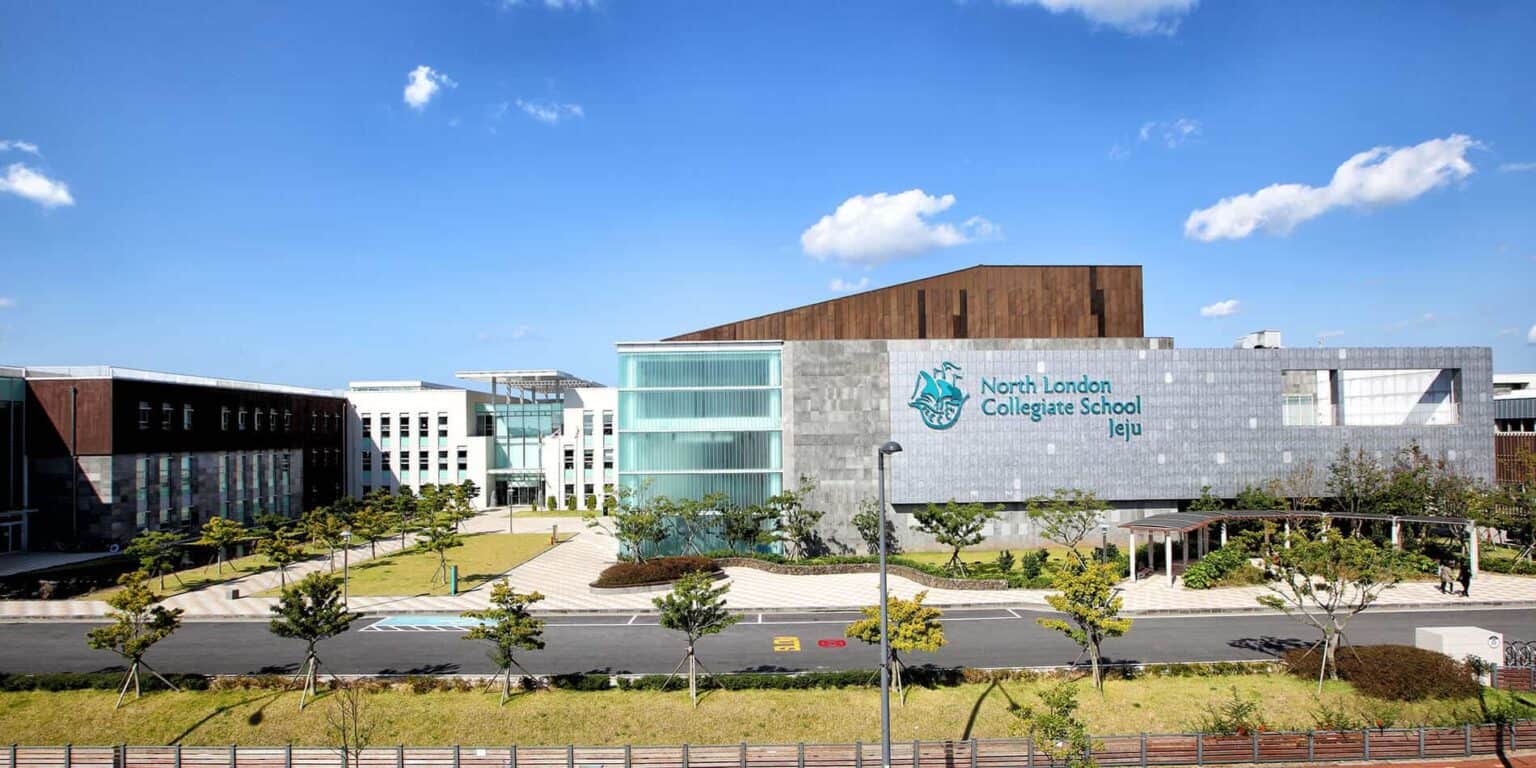 Modern North London Collegiate School Jeju campus with innovative architecture and lush landscaping, offering top international education.