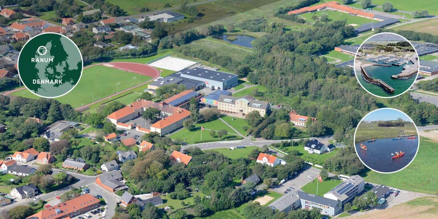 Aerial view of a Danish school campus with sports fields, surrounded by greenery and residential homes.