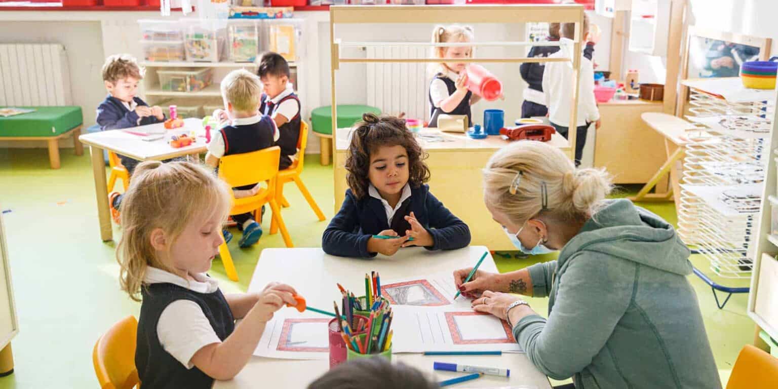 Bright classroom with young children engaging in creative activities at World Schools.