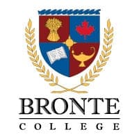 Modern school crest with shield and laurel wreath emphasizing excellence and tradition.