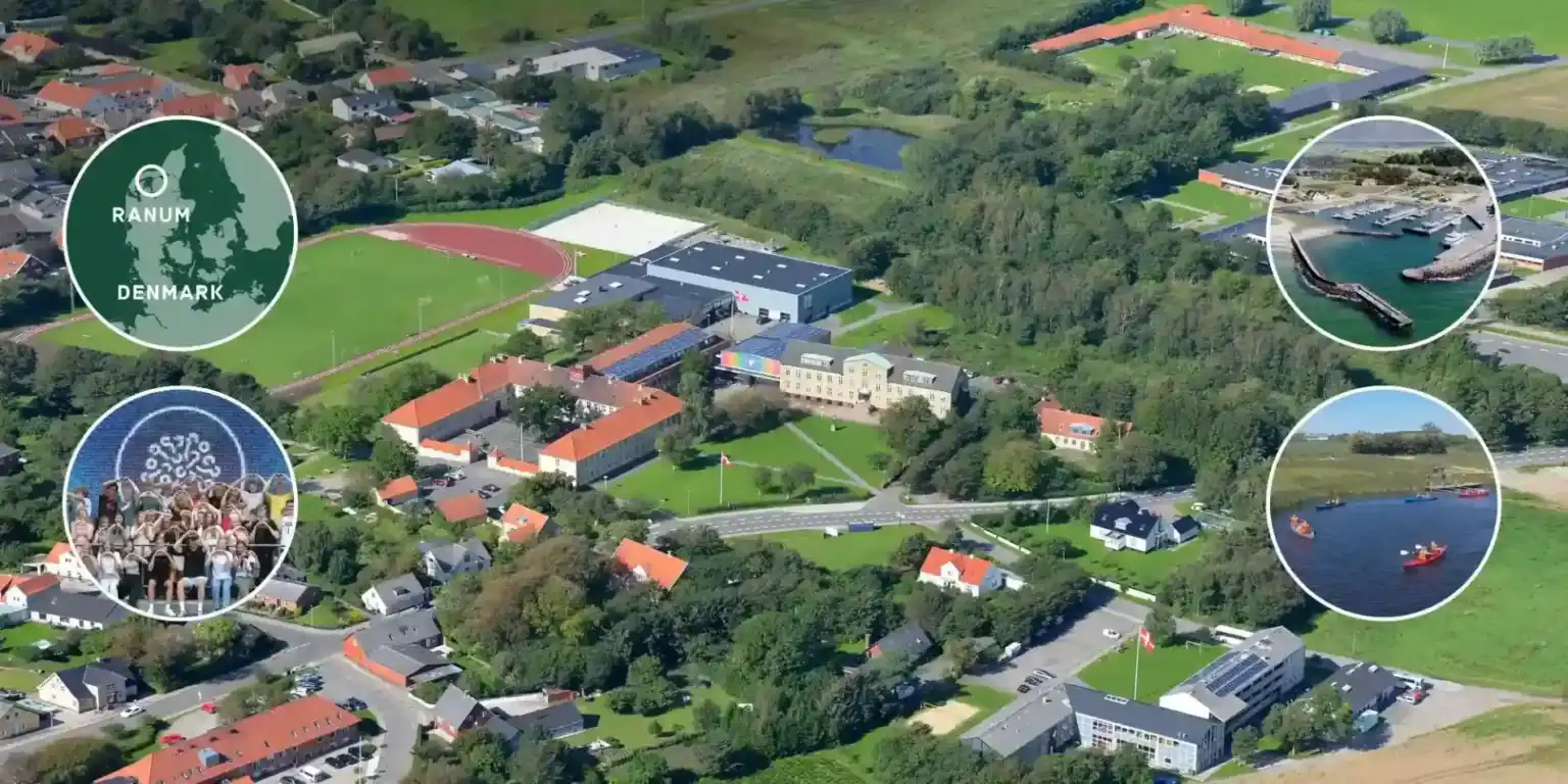 Modern school campus nestled in lush green landscape in Denmark with sports facilities and water views.